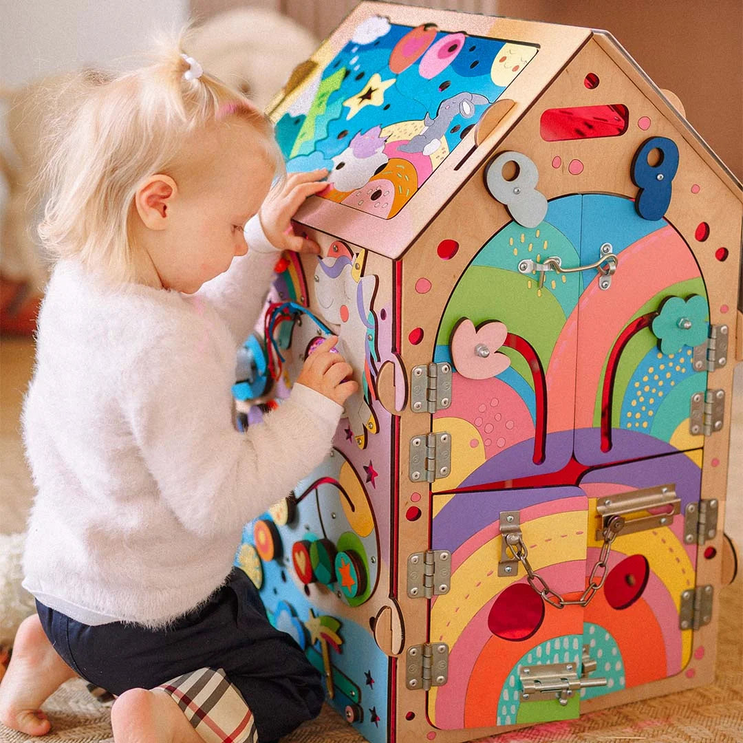 baby exploring toy house