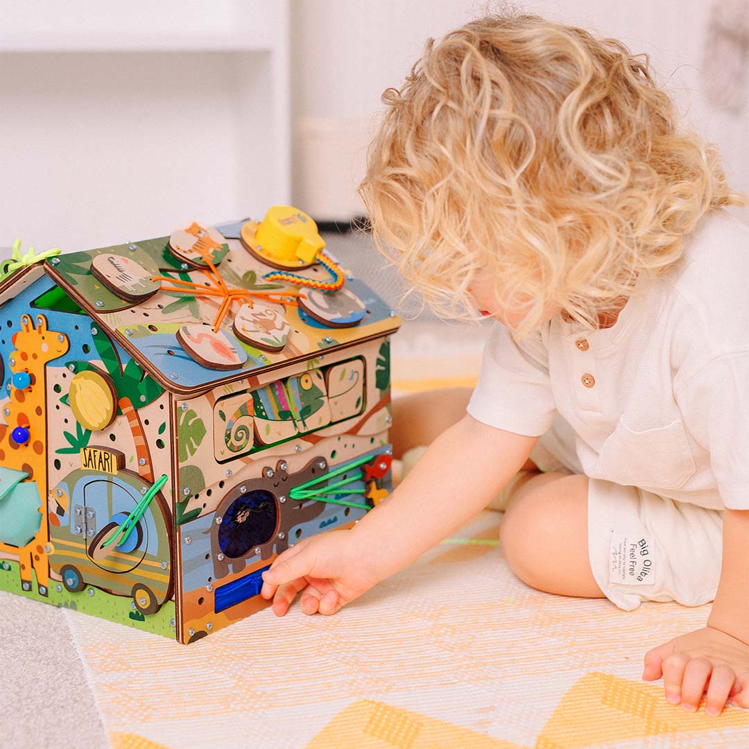baby playing with safari activity cube