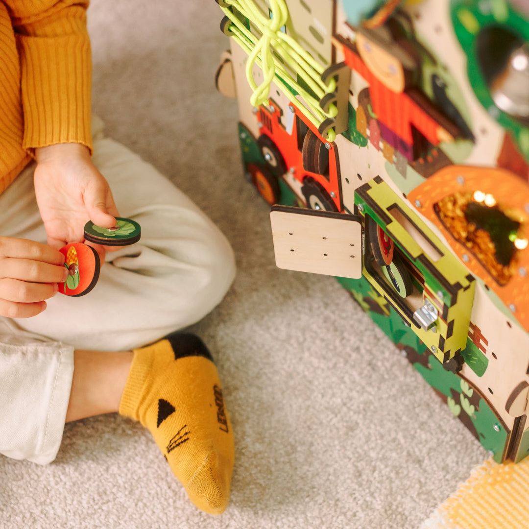 child exploring farm doors and puzzles