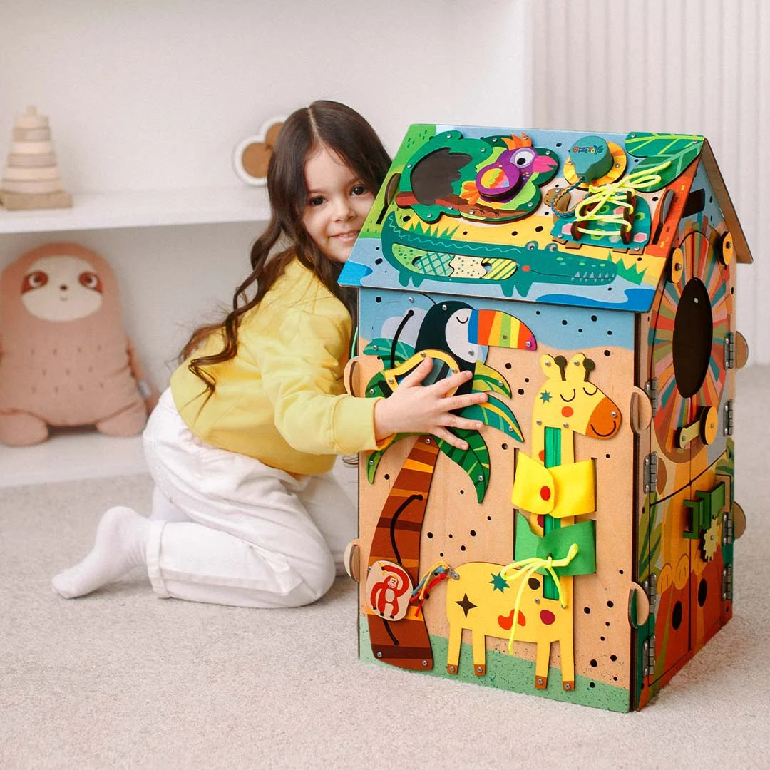 Toddler hands exploring Montessori busy board