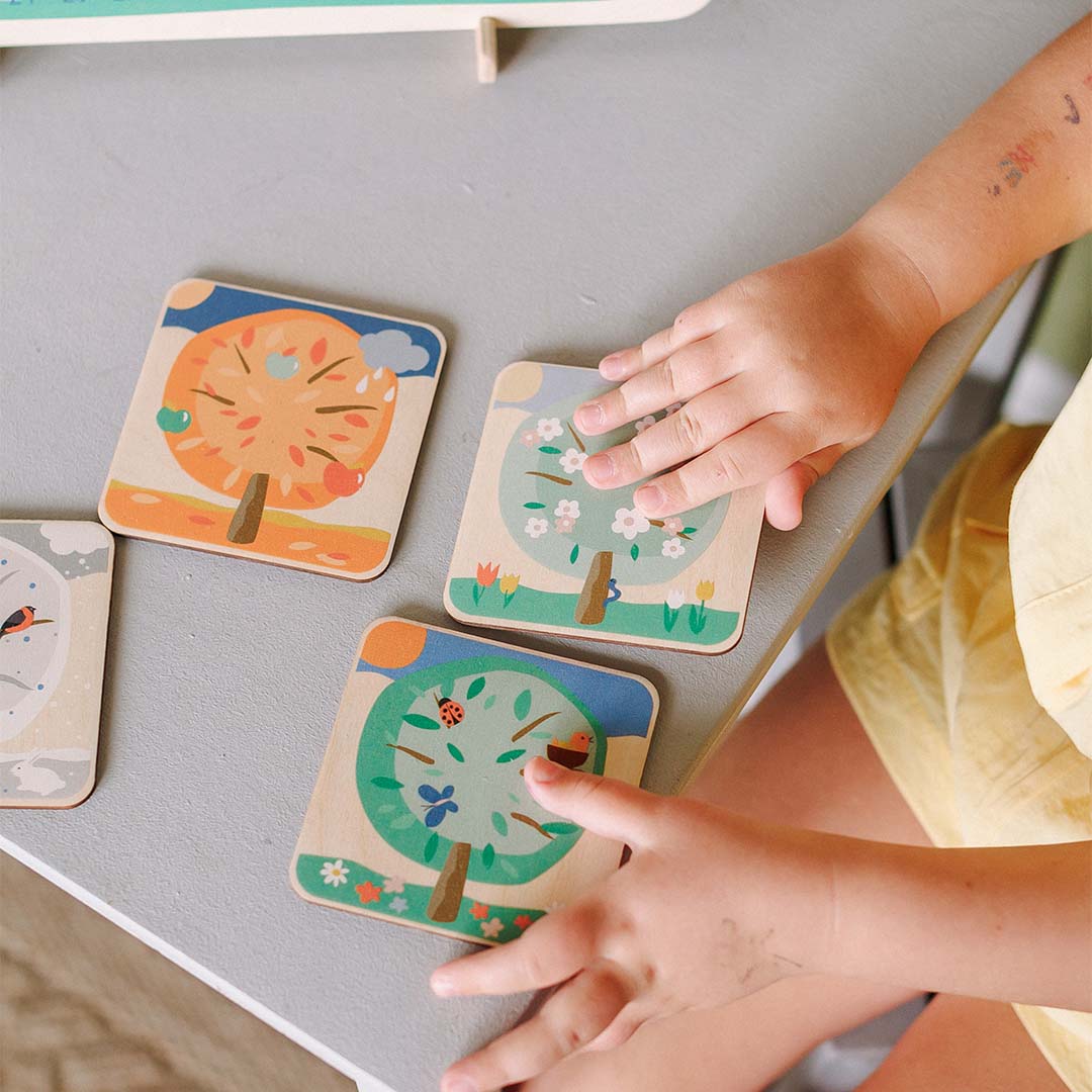 kids adjusting season plate on calendar