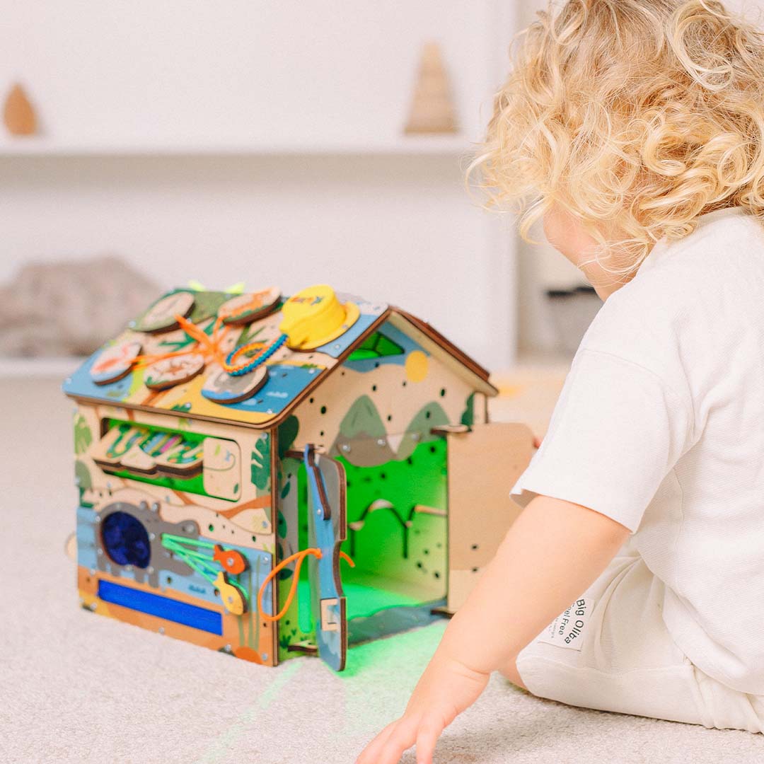 toddler opening door on play cube