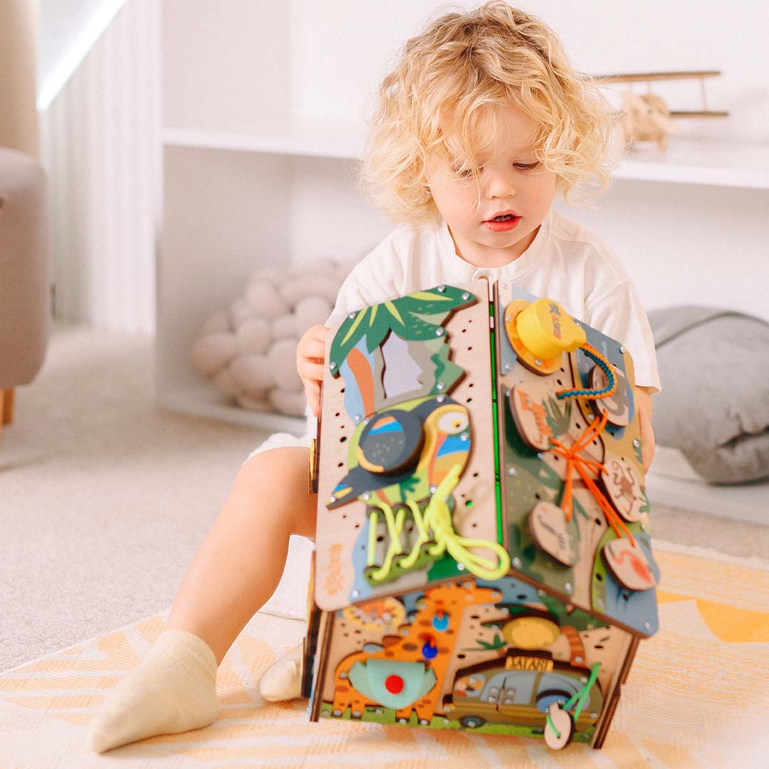 toddler exploring bead giraffe panel