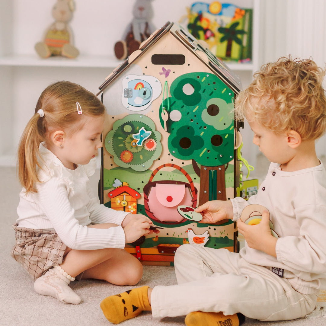 toddlers playing with activity cube