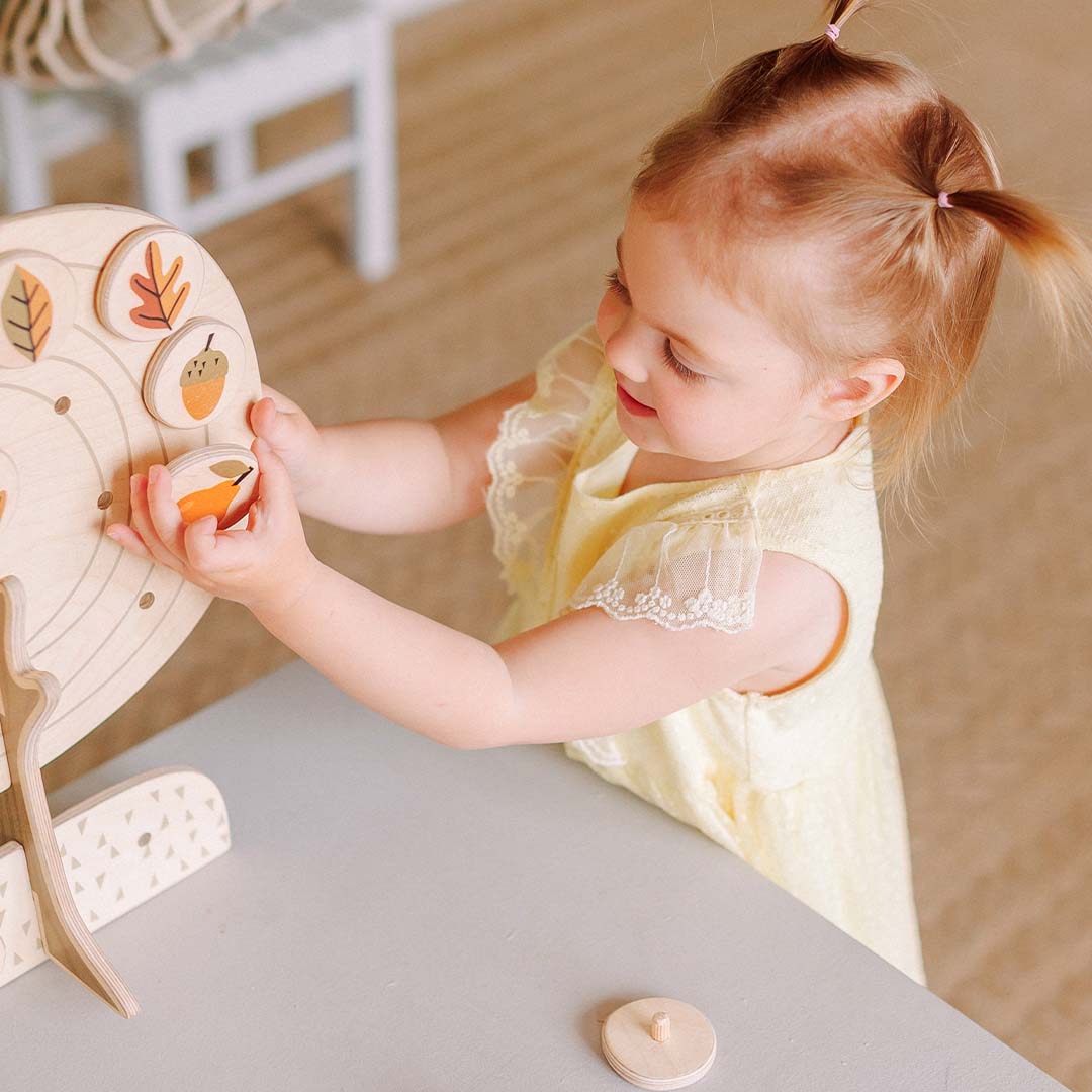 toddler playing with seasons puzzle