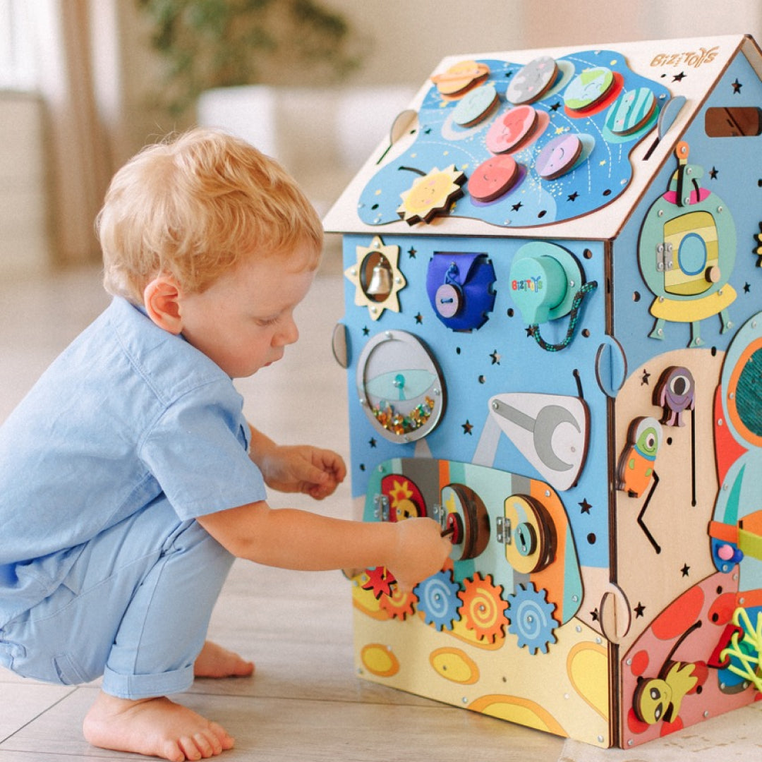 toddler playing with space cube