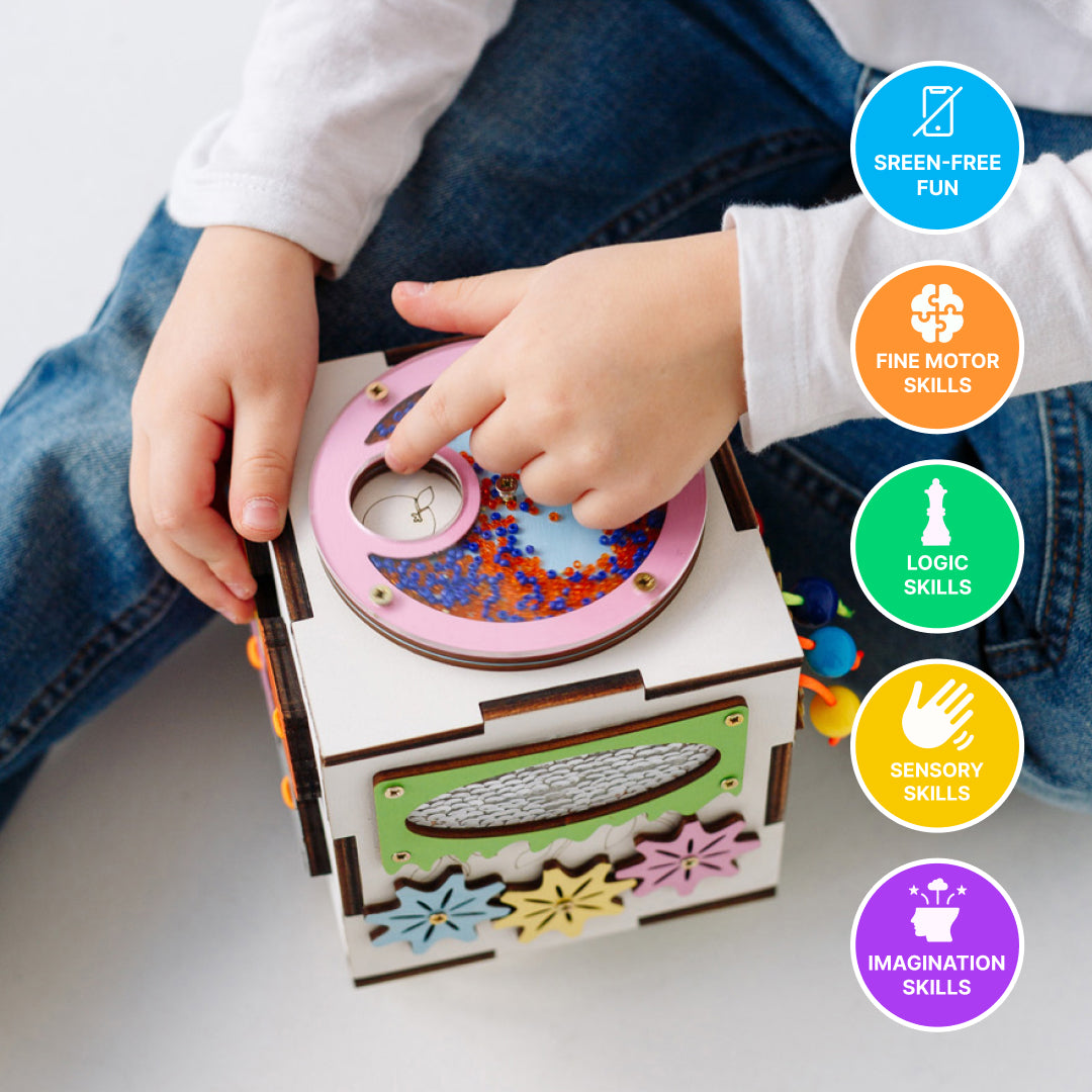 child exploring wooden activity cube