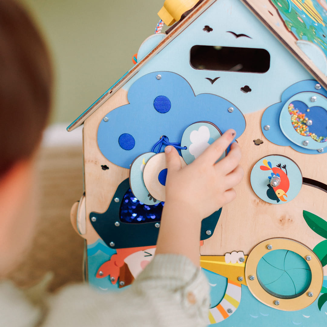 toddler matching velcro shapes on busy board